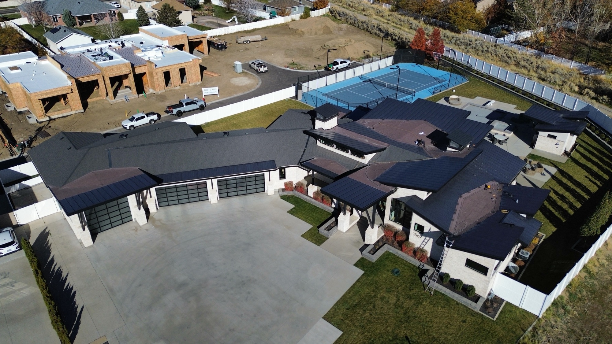 Aerial view of a large luxury home with a newly installed architectural shingle roof in the Salt Lake Valley