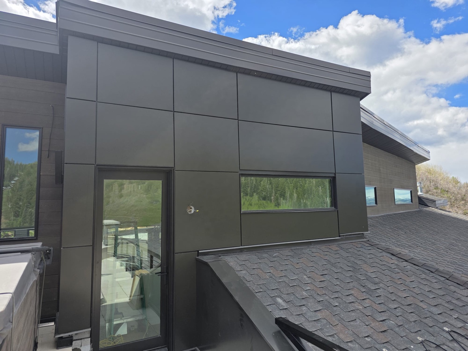 Dark metal panel siding on a modern Park City home